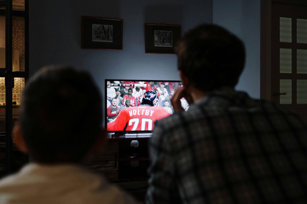 A man and his partner watching Netflix together, enjoying a quiet and cozy moment in front of the TV.